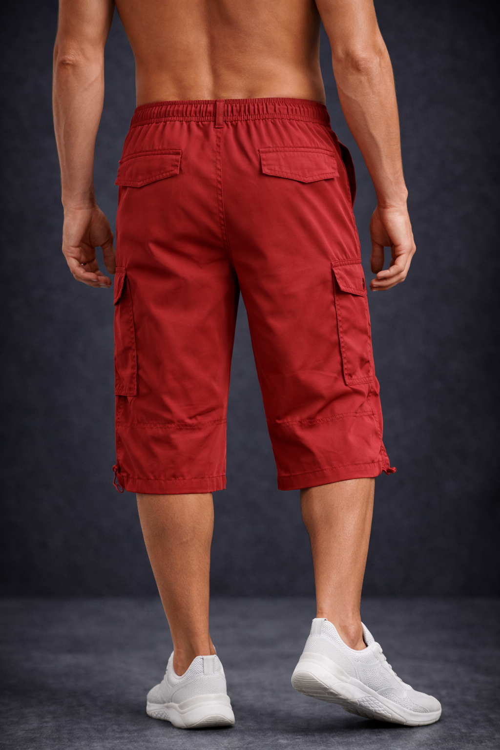 Man dressed in red shorts and black background