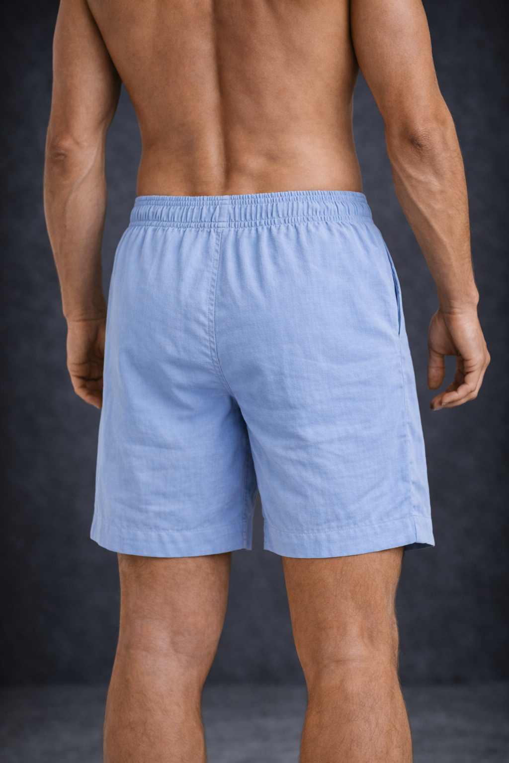 Man wearing blue shorts and dark bottom